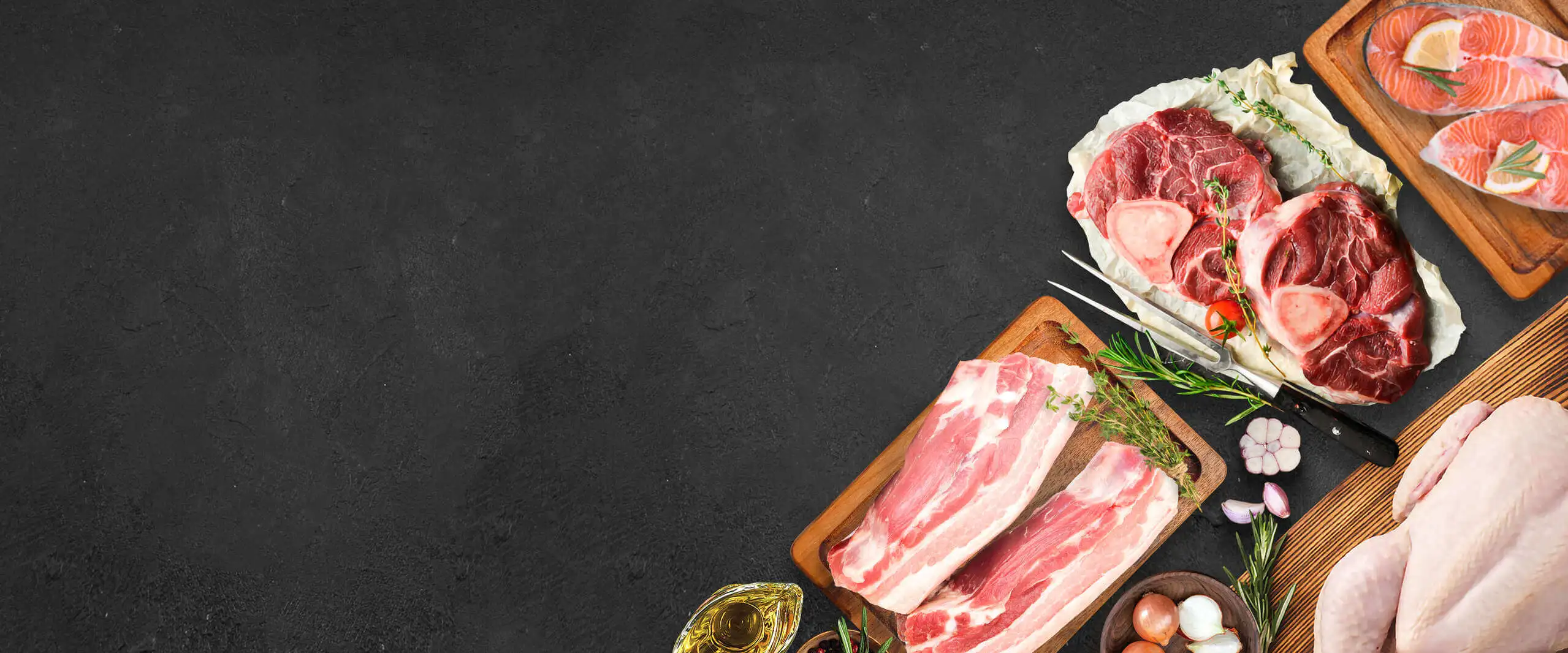 Assorted fresh meats and ingredients laid out on a board